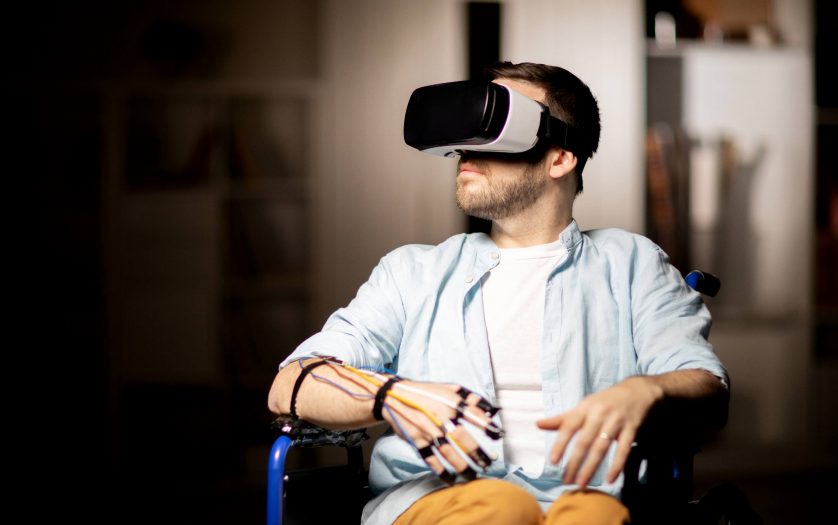 A guy in a wheelchair using a VR headset